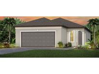 Charming one-story home with a two-car garage, landscaped yard, and an inviting facade at 9530 Coastline Way, Parrish, FL 34219