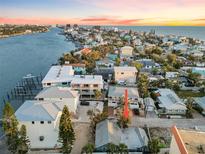 Waterfront neighborhood featuring homes with scenic views of the water at sunset at 150 95Th Ave, Treasure Island, FL 33706
