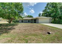 Charming single-Gathering home featuring well-maintained landscaping and a two-car garage at 3206 Shalimar Ter, North Port, FL 34286