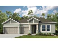 Inviting single-story home featuring a two-car garage, stylish architectural details, and lush landscaping at 3213 Lumber Falls Dr, Plant City, FL 33565