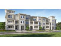 Charming multi-story townhomes with white trim, covered patios, and well-manicured landscaping at 3562 Silent Gardens Cv, Wesley Chapel, FL 33543