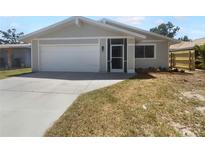 Charming single-story home featuring a two-car garage, screened entry, and freshly landscaped front yard at 804 Pineland Ave, Venice, FL 34285