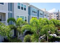 Charming townhome showcasing a lovely facade and complemented by lush, mature palms at 813 Burlington N Ave, St Petersburg, FL 33701