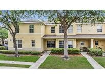 Charming townhome with a well-maintained lawn and lush shrubbery in a tranquil neighborhood at 10906 Keys Gate Dr, Riverview, FL 33579