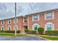 Classic brick condo building with white shutters and neatly trimmed shrubs at 3510 41St S Ave # 168, St Petersburg, FL 33711