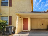 Inviting exterior showcasing the front door and private covered parking area at 7535 Abonado Rd, Tampa, FL 33615