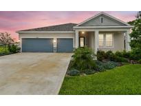 Charming single-story home with a well-manicured lawn, two-car garage and beautiful landscaping at 8960 Windlass Cv, Parrish, FL 34219