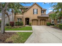 Charming two-story home with a well-manicured lawn, mature trees, and a two-car garage at 11607 Meridian Point Dr, Tampa, FL 33626
