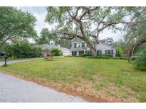 Charming two-story home with a lush green lawn and mature trees in a desirable neighborhood at 2305 S Hesperides St, Tampa, FL 33629