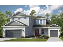 Two-story home with gray siding, gray roof, a two car garage and nicely manicured green grass at 3405 Lumber Falls Dr, Plant City, FL 33565