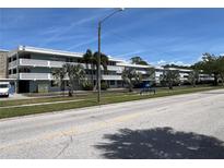 A well maintained three story condominium building with lush landscaping on a beautiful, sunny day at 4715 Bay Ne St # 235, St Petersburg, FL 33703