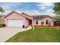Charming single-story home showcasing a well-manicured lawn and a two-car garage at 502 36Th W St, Palmetto, FL 34221
