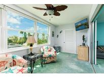 Bright living room featuring large window views, comfortable seating, and a coastal-themed decor at 5575 Gulf Blvd # 421, St Pete Beach, FL 33706