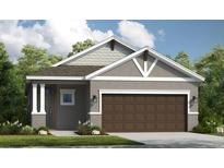 Charming single-story home boasts a symmetrical design, neutral tones and a spacious two-car garage at 819 Steel Dr, Apollo Beach, FL 33572