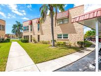 Charming two-story condo with lush landscaping and carport in a vibrant community at 101 Dogwood Cir, Seminole, FL 33777