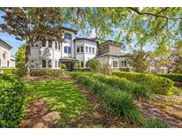 Lush front lawn with manicured landscaping and a brick walkway leading to an elegant home at 1058 Roundstone Pl, Palm Harbor, FL 34683