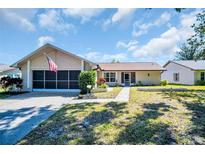 Charming single-story home featuring a well-manicured lawn, attached garage, and inviting curb appeal at 1657 Glengarry Dr, Palm Harbor, FL 34684