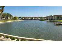 Scenic water view overlooking a canal with lush landscaping and buildings on both sides under a clear blue sky at 19029 Us Highway 19 N # 8-13, Clearwater, FL 33764