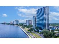 Modern high-rise condo building with waterfront views and blue skies at 2912 W Santiago St # 1401, Tampa, FL 33629