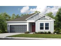 Charming single-story home with a gray two-car garage and a well-manicured lawn at 3408 Lumber Falls Dr, Plant City, FL 33565