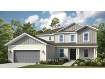 Charming two-story home with a gray garage, complemented by lush landscaping and an inviting entrance at 3415 Lumber Falls Dr, Plant City, FL 33565