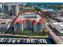 Beautiful waterfront condo complex featuring red tile roof, central pool, and private boat slips with direct access to the open ocean at 700 S Harbour Island Blvd # 547, Tampa, FL 33602