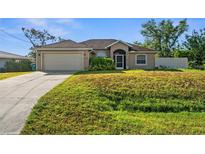 Charming one-story home with a well-maintained lawn and attached two-car garage at 7288 Castleberry Ter, Englewood, FL 34224