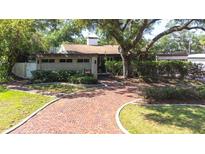 Charming home with mature landscaping and a brick walkway leading to the front entrance at 8238 30Th N Ave, St Petersburg, FL 33710