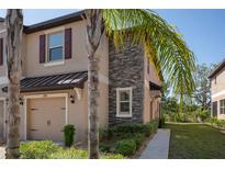 Charming two-story townhome featuring stone accents and a one-car garage at 11704 Castine St, New Port Richey, FL 34654