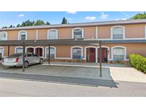 Charming townhome with covered parking and well-maintained landscaping enhances curb appeal at 14910 Par Club Cir, Tampa, FL 33618