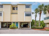 Charming two-story townhouse with tropical landscaping and covered parking at 1500 Sunset Rd # F8, Tarpon Springs, FL 34689