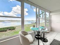 Bright breakfast nook features stunning water views from the large windows and a glass table with seating for two at 1847 Shore S Dr # 204, South Pasadena, FL 33707