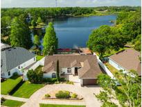 Stunning waterfront property with a well-maintained yard and private dock on a serene lake at 2347 Foggy Ridge Pkwy, Land O Lakes, FL 34639