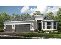 Beautiful single-story home with a three-car garage, stone accents, and a well-manicured lawn at 29936 Rusco Ct, Wesley Chapel, FL 33543