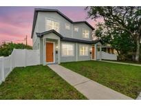 Charming two-story home featuring a well-manicured lawn and inviting entrance at 3457 17Th S Ave, St Petersburg, FL 33711