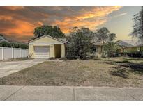 Charming single-story home with attached garage and mature trees in a quiet neighborhood at 3647 Lake St George Dr, Palm Harbor, FL 34684