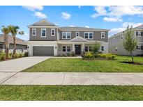 Beautiful two-story home featuring manicured lawn, neutral color palette, and attached two car garage at 4423 Pond Brook Ct, Bradenton, FL 34211
