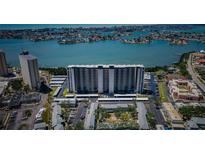 Stunning aerial view of a modern high-rise building, with coastal views and covered parking at 7050 Sunset S Dr # 912, South Pasadena, FL 33707
