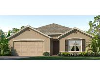 Charming one-story home featuring a two-car garage, landscaped front yard, and a neutral stucco exterior at 1430 Brown Mallet Pl, Ruskin, FL 33570
