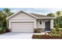 Charming single-story home with a two car garage, well-manicured landscaping, and a stylish front door at 32708 Winterwood Blvd, Wesley Chapel, FL 33543