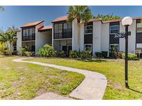 Inviting exterior of a condominium featuring well-maintained landscaping and a charming walkway leading to the entrance at 3281 Beneva Rd # 202, Sarasota, FL 34232