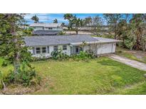 Charming single-story home with a well-maintained lawn and mature landscaping at 723 45Th Street W Ct, Palmetto, FL 34221