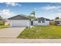 Charming single-story home with a well-manicured front yard and a two-car garage at 12641 98Th St, Largo, FL 33773