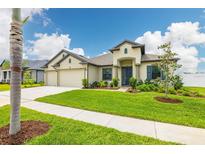 Inviting single-story home showcasing a well-manicured lawn, charming landscaping, and a convenient three-car garage at 3503 Gaviota Dr, Sun City Center, FL 33573