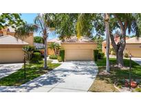 Charming single-story home featuring a well-maintained yard, two-car garage, and tile roof at 9308 Fairway Lakes Ct, Tampa, FL 33647