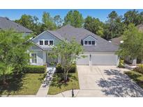 Charming two-story home boasts a well-manicured lawn and a two-car garage at 14705 Canopy Dr, Tampa, FL 33626