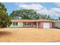 Charming single-story home with a brick facade, attached garage, and well-maintained landscaping at 1758 Southview Rd, Largo, FL 33770