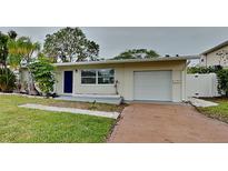 Charming single-story home with a well-manicured lawn and attached garage at 1835 Nevada Ne Ave, St Petersburg, FL 33703