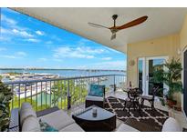Relax on this beautiful balcony with water views, ceiling fan, and stylish outdoor furniture for ultimate comfort at 425 150Th Ave # 2501, Madeira Beach, FL 33708