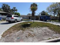 Charming single-story home featuring a carport, driveway, and landscaped front yard with a mature palm tree at 4327 Huntington Ne St, St Petersburg, FL 33703